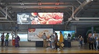 Big Tree digital display inside a transit concourse